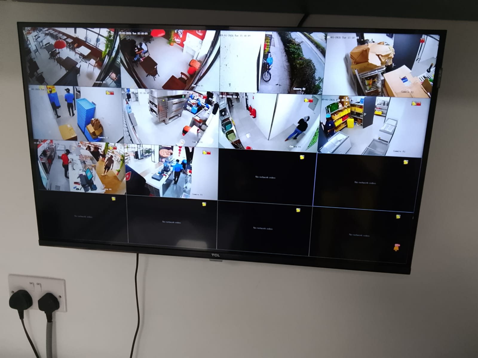 CCTV monitor showing a multi-camera view of a restaurant installation